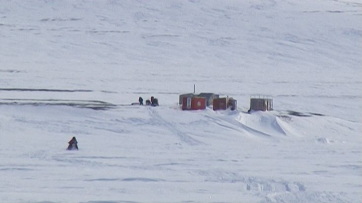 Arriving by snowmobile to Inuit log cabins in the Devon Island - Nanoq 2007 expedition