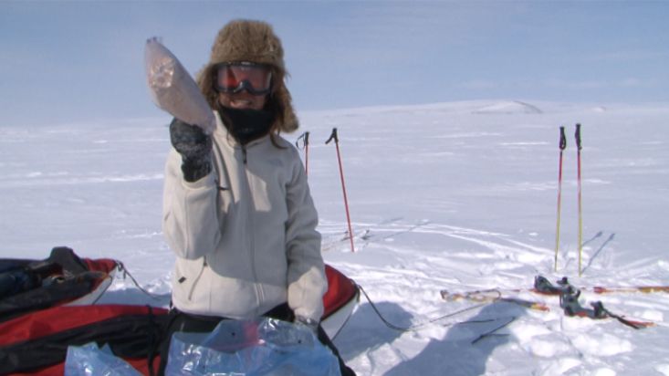 Ingrid unearhting the food of the portage from the snow - Penny Icecap 2009 expedition