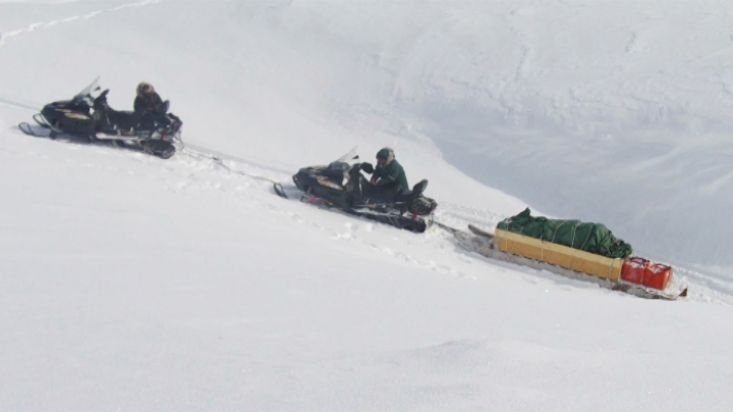 Snowmobiles stuck on a snowy slope - Barnes Icecap expedition - 2012